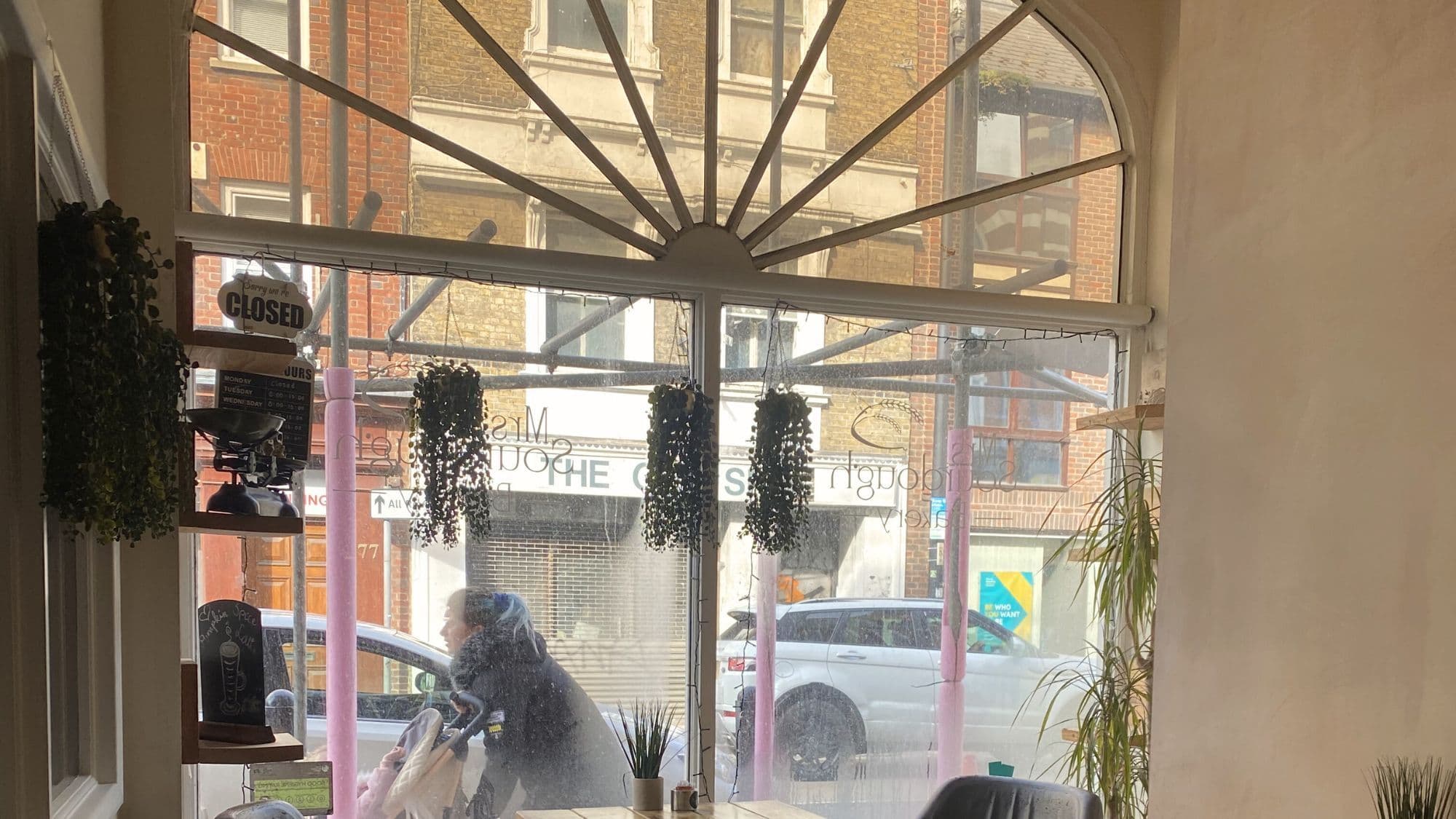 Arched front window and seating inside Mrs Sourdough Bakery in Chatham looking onto the High Street