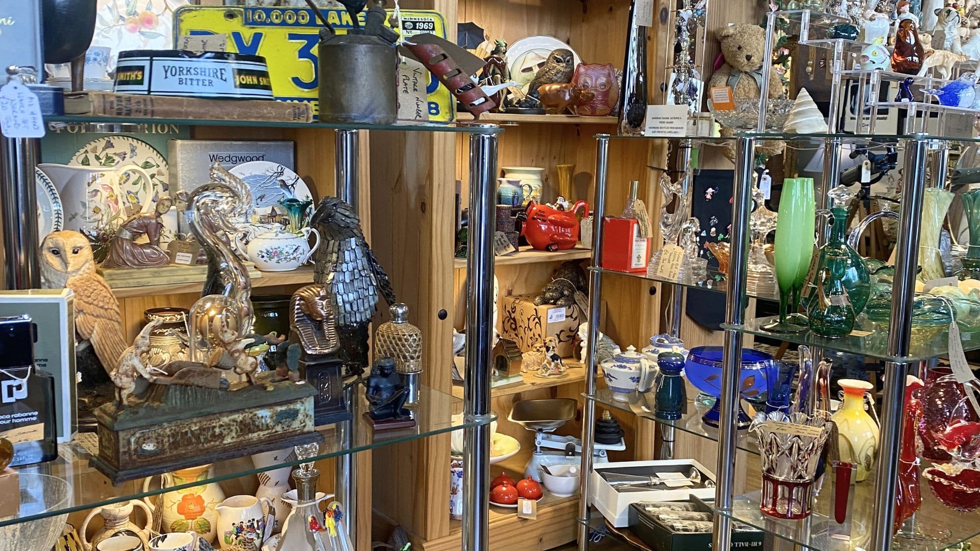 interior of Kaboodles antiques emporium in Rochester with cabinets of vintage objects, glassware and collectibles
