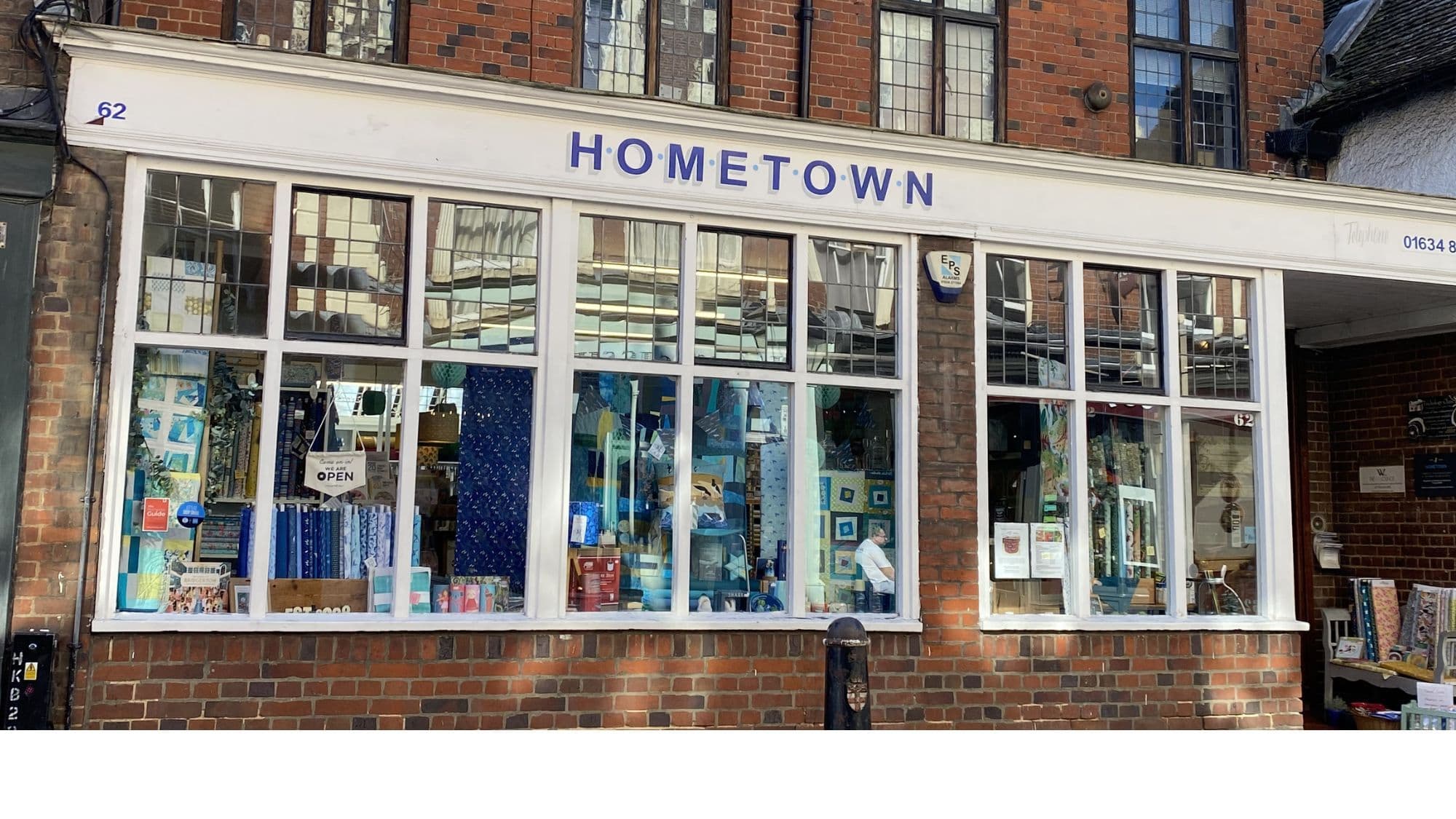 Exterior of Hometown fabric shop on Rochester High Street with large windows and signage
